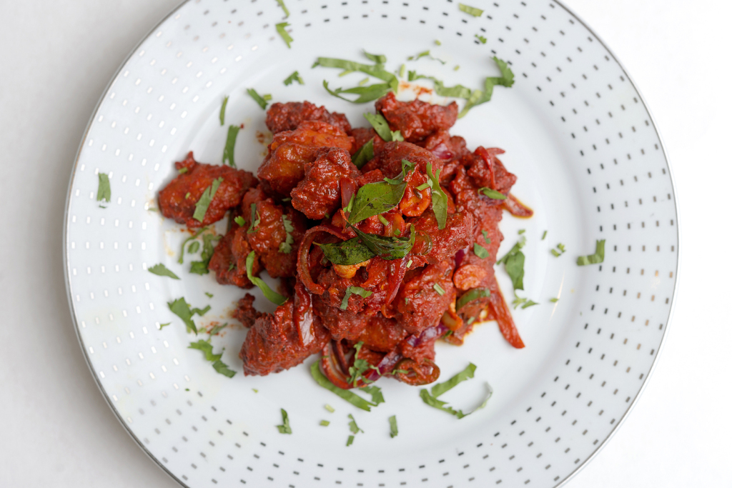 Red cashmere chili gives the Chicken 65 appetizer its bright hue.