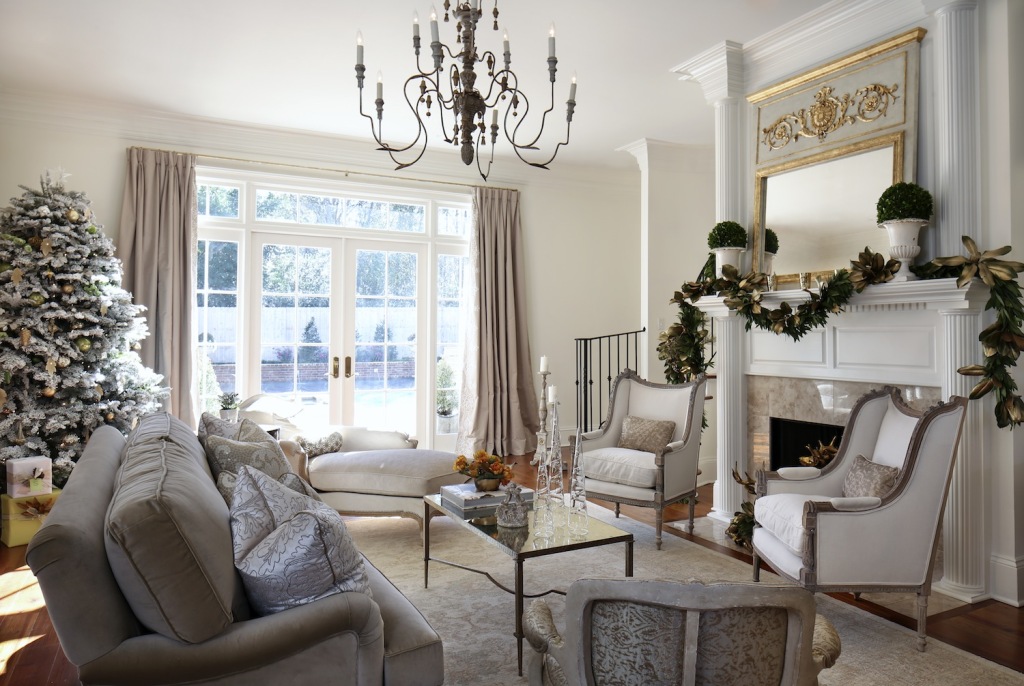 The look of the formal living room, Alayna’s favorite room in the house, was inspired by the graceful homes of the Garden District in her hometown of New Orleans. The soothing palette of whites and creams is balanced by accents like a Trumeau mirror by Julie Neill and an Italian chandelier. 