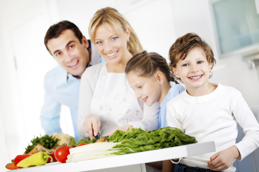 Happy family are preparing a healthy dinner at home.