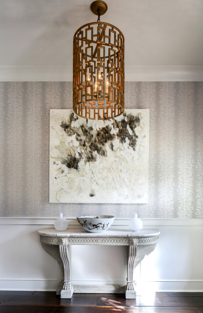 An abstract painting by New Orleans artist Karoline Schleh is set against subtly shimmering Anna French wallpaper in the foyer, providing what McCanless calls a “wow factor” in a small space.