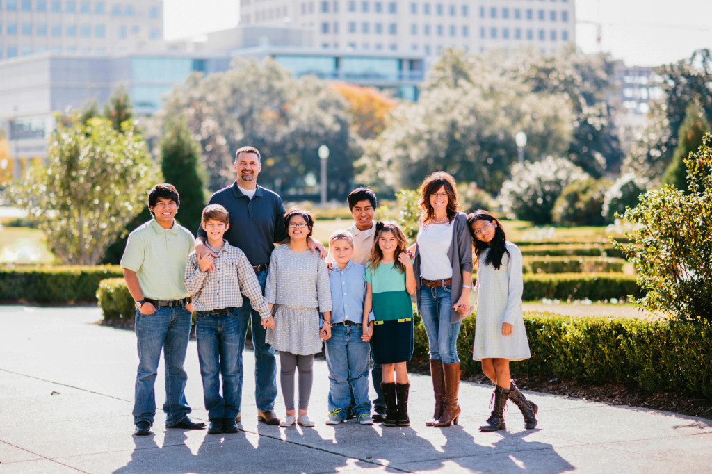 The Poches have adopted five of their children. Pictured from left to right: Anthony, Asa, Tommy, Zoë, Elijah, Henry, Grace, Aimee, Rose and Heidi (not pictured). Image courtesy Aimee Poche/Marissa Lambert Photography