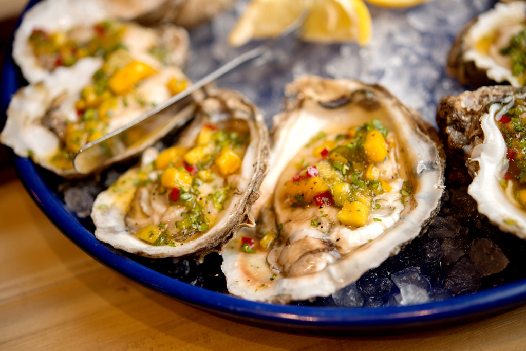 A bright and citrusy Mango Rum Salsa is one of several toppings for raw oysters.