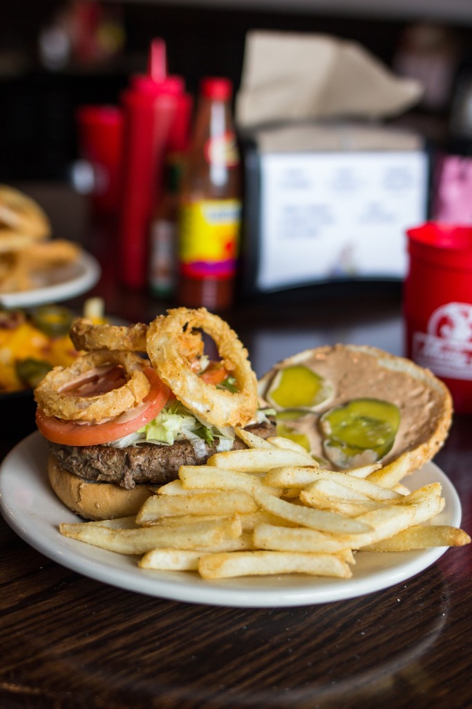 The Lil Lenny Burger is topped with Lil Lenny’s dipping sauce and fried onion rings. 