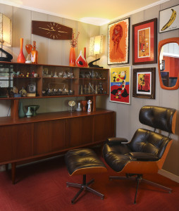 Kerry says sitting in her blonde wood reproduction Eames chair is “like sitting in a hug—it’s so comfortable.” The Sunbeam clock on the wall above the cabinet is the same style the character Joan had in her office on the TV show Mad Men; inside the cabinet is a set of silver-rimmed whiskey glasses just like the ones Don Draper had on the show.