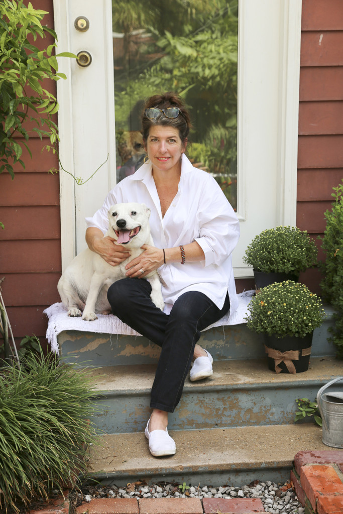 Julie Bergeron sits on the back stoop with her dog Willie.