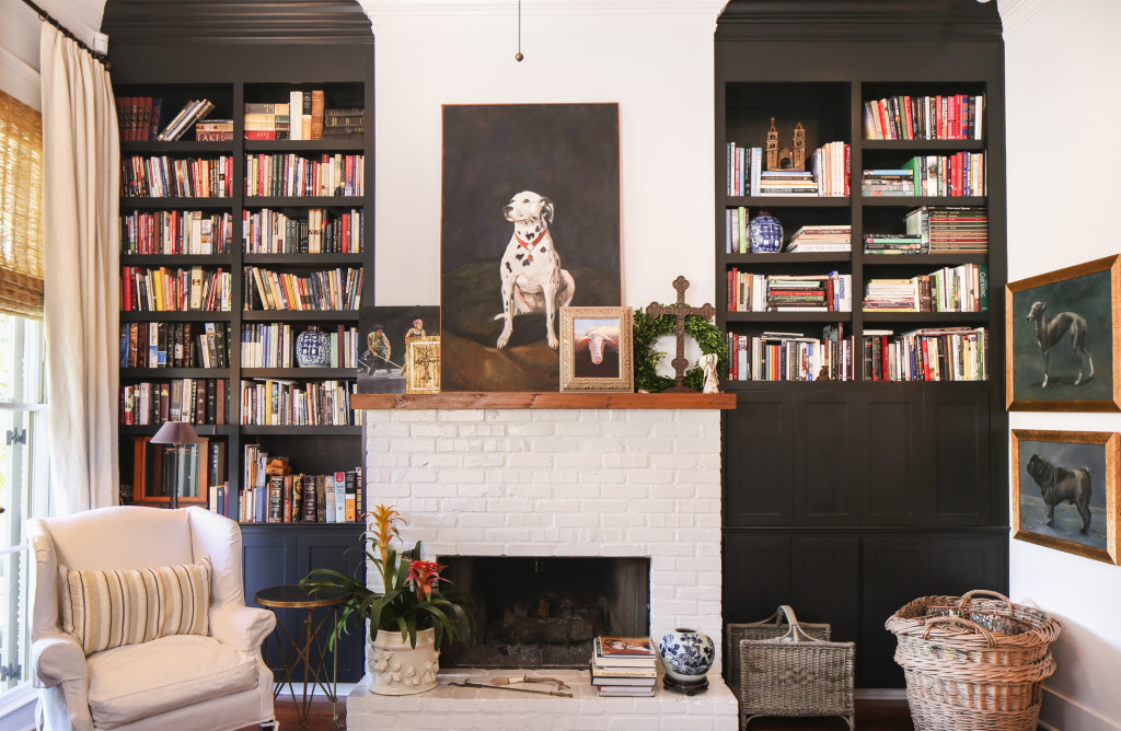 Black-painted built-in bookshelves and a Dalmatian painting by Libby Johnson make a strong impact on the living room’s fireplace wall. “All of the artwork in the house is very personal to us,” says Rachel. “Everything’s got a story, and everything came at a season in our lives.”