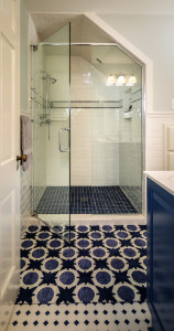 An upstairs bathroom was completely gutted and reconfigured. “We made sure to choose tiles and lights that were true to the time period,” says Coco.