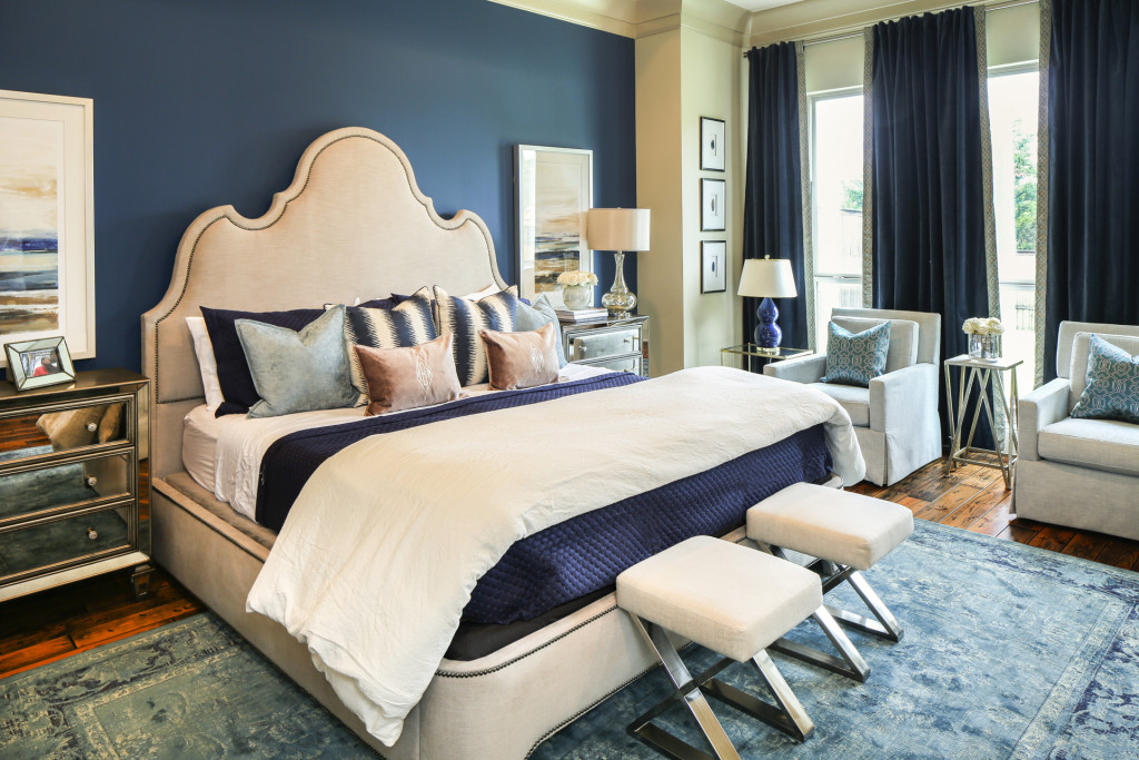 "I wanted a bedroom that felt like we were at a resort," Bellizaire says. She painted one wall a deep blue--Sherwin Williams' "Loyal"--and chose a sculpted upholstered bed from Red Door Interiors.